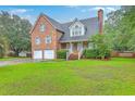 Charming brick home with two-car garage and well-maintained lawn at 125 Eston Dr, Goose Creek, SC 29445