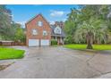 Charming brick home with two-car garage, palm tree, and manicured lawn at 125 Eston Dr, Goose Creek, SC 29445