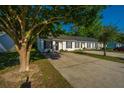 A beautiful exterior view of a townhome with mature trees surrounding the property at 1327 Pinnacle Ln, Charleston, SC 29412