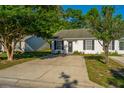 Exterior view of townhouses with mature trees, and well-maintained grounds and plantings at 1327 Pinnacle Ln, Charleston, SC 29412