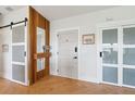 Modern entryway with wood accent wall, herringbone floors, and stylish doors at 1467 Battalion Dr, James Island, SC 29412