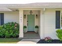 Charming front entrance with a decorative teal door and blooming hydrangeas at 1467 Battalion Dr, James Island, SC 29412