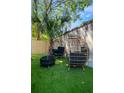 Cozy backyard space featuring comfortable seating arrangements and manicured synthetic grass at 15 H Street St, Charleston, SC 29403
