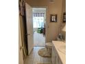 A bathroom with tiled floors that opens to a bedroom area with an open window at 1600 Long Grove Dr # 411, Mount Pleasant, SC 29464