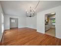 Spacious dining area featuring hardwood floors, neutral paint, modern lighting and a glimpse of the kitchen at 1673 Sulgrave Rd, Charleston, SC 29414