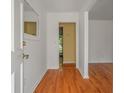 View of the entryway with hardwood floors, crisp white walls and a glimpse of the home's interior at 1673 Sulgrave Rd, Charleston, SC 29414