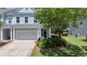 Charming two-story home featuring a two-car garage, well-manicured lawn, and inviting curb appeal at 1709 Blalock St, Mount Pleasant, SC 29466