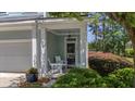 Inviting covered front porch with rocking chairs and well-maintained landscaping at 1709 Blalock St, Mount Pleasant, SC 29466