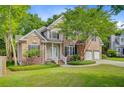 Inviting brick home with a lush green lawn and mature tree, offering a desirable curb appeal at 1851 Oleander Ct, Charleston, SC 29414