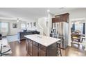 Open-concept kitchen featuring a large island, stainless steel appliances, and hardwood floors at 192 Weeping Cypress Dr, Moncks Corner, SC 29461