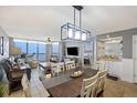 Open-concept living and dining area with ocean views and access to a private balcony at 201 W Arctic Ave # 406, Folly Beach, SC 29439