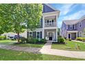 Inviting two-story home with a cozy front porch swing and well-manicured lawn at 2025 Maybelles Ln, Charleston, SC 29414