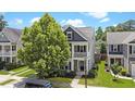 A beautiful two-story home with a balcony, complemented by lush greenery and mature trees at 2025 Maybelles Ln, Charleston, SC 29414