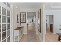 Inviting foyer with light wood floors, decorative accents, and views into the living spaces at 2184 Tall Grass Cir, Mount Pleasant, SC 29466