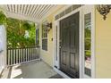 The front door is framed by sidelights, decorative molding, and complemented by hanging ferns on a covered porch at 2184 Tall Grass Cir, Mount Pleasant, SC 29466
