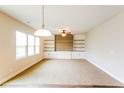 Bright living room featuring modern ceiling fan, recessed lighting, and built-in shelving at 241 Wathen Dr, Goose Creek, SC 29445
