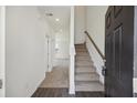Bright entryway with stairs leading up and hardwood floors flowing into carpeted living spaces at 278 Catawba Branch Way, Moncks Corner, SC 29461