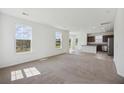 Spacious living room with abundant natural light, neutral carpet, and an open-concept design at 278 Catawba Branch Way, Moncks Corner, SC 29461