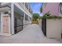 Open driveway next to a two-story house, featuring a gated entrance for privacy at 29 Bogard St, Charleston, SC 29403