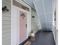 Cozy front porch with a 'welcome' mat, potted plant, and a charming painted ceiling at 29 Bogard St, Charleston, SC 29403