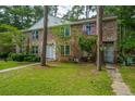 Charming brick townhouse with a well-maintained lawn and mature trees providing shade at 306 Crestview Dr # C, Summerville, SC 29485
