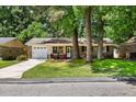 Charming brick home with well-maintained lawn, a driveway, and inviting front porch seating at 315 Elliott Dr, Ladson, SC 29456