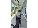 Inviting front porch with rocking chairs, swing, and stylish lighting fixtures at 318 Ripple Park Dr, Summerville, SC 29486