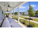Relax on this inviting front porch swing, complete with a ceiling fan for warm days at 318 Ripple Park Dr, Summerville, SC 29486