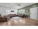 Bright living room with hardwood floors, large windows, plenty of seating and white walls at 326 Surfbird Rd # 388, Summerville, SC 29486