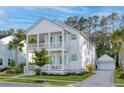 Inviting two-story home with double porches, featuring a long driveway to the detached garage at 4114 Maidstone Dr, Mount Pleasant, SC 29466