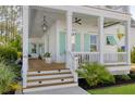 Inviting front porch with pendant light, ceiling fan, and steps leading to the entry of this beautiful home at 4114 Maidstone Dr, Mount Pleasant, SC 29466