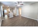 Open-concept design integrates the kitchen into the living space with wood-look floors and neutral paint at 4818 Holly Berry Ln, Summerville, SC 29485