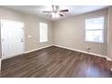 A well-lit living room is brightened by two windows and features wood-look flooring and a ceiling fan at 4818 Holly Berry Ln, Summerville, SC 29485