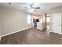 A view of the living room with wood-look floors transitions into the kitchen with an archway entrance at 4818 Holly Berry Ln, Summerville, SC 29485