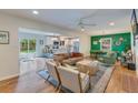 Open-concept living room showcases hardwood floors and seamless transition to the modern kitchen and dining area at 4924 France Ave, North Charleston, SC 29405
