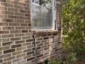 Shows deterioration of the mortar on the foundation of this brick house and cracking below a window sill at 5 Apple Cir, Goose Creek, SC 29445