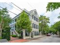 Elegant multi-story home showcasing architectural details, landscaping, and a gated entrance at 5 Legare St # C, Charleston, SC 29401