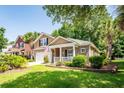 Charming two-story home with brick accents, front porch, attached garage, and manicured lawn at 5002 W Liberty Meadows Dr, Summerville, SC 29485