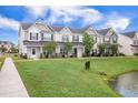 Beautiful townhome exteriors overlooking the community pond, enhancing the neighborhood's charm at 502 Duskywing Dr, Goose Creek, SC 29445