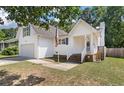 Well-maintained two story home with siding, garage, and front lawn at 5052 Hidden Forest Ln, North Charleston, SC 29420