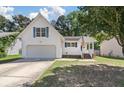 Well-maintained two story home with siding, garage, and front lawn at 5052 Hidden Forest Ln, North Charleston, SC 29420