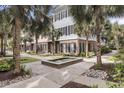Beautiful townhome with a fountain and meticulous landscaping creates a welcoming curb appeal at 656 Coleman Blvd # 703, Mount Pleasant, SC 29464