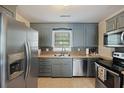 Stylish kitchen featuring stainless steel appliances, wood countertops, and modern blue cabinets at 825 Savage Rd, Charleston, SC 29414