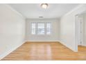 Empty dining room with hardwood floors, white walls, and large windows at 8612 Delhi Rd, North Charleston, SC 29406