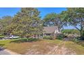 Charming home with well-maintained lawn, mature trees, and a long drive, creating a welcoming curb appeal at 932 N Shem Dr, Mount Pleasant, SC 29464