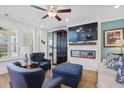 Comfortable living room with an electric fireplace, large TV, blue leather chairs, and lots of light at 101 Caleb Ct, Ladson, SC 29456