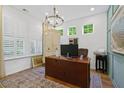Well-lit office features plantation shutters, a chandelier, and a charming color scheme at 101 Caleb Ct, Ladson, SC 29456