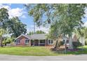 Attractive brick home with lush landscaping providing privacy and curb appeal at 1027 E Recess Rd, Hanahan, SC 29410