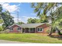 Well-maintained brick home with a neatly kept lawn and a welcoming facade at 1027 E Recess Rd, Hanahan, SC 29410