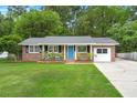 Charming brick home with a well-manicured lawn and a welcoming light blue front door at 105 Bermuda Ct, Summerville, SC 29485